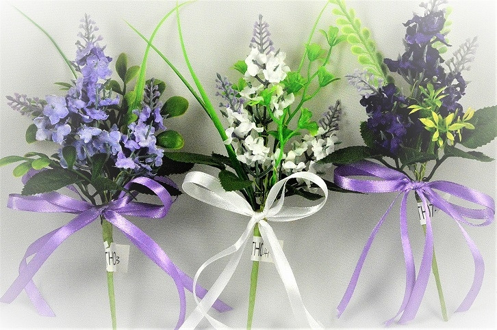 33002 - Floral arrangement with delicate flowers and leaves embellished with a satin bow.  Height  20cms ,  Width  11cms  (approx) 